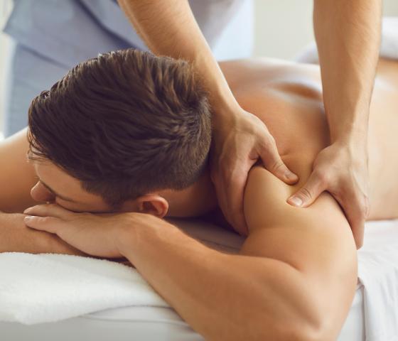 person receiving a massage on the shoulder and arm